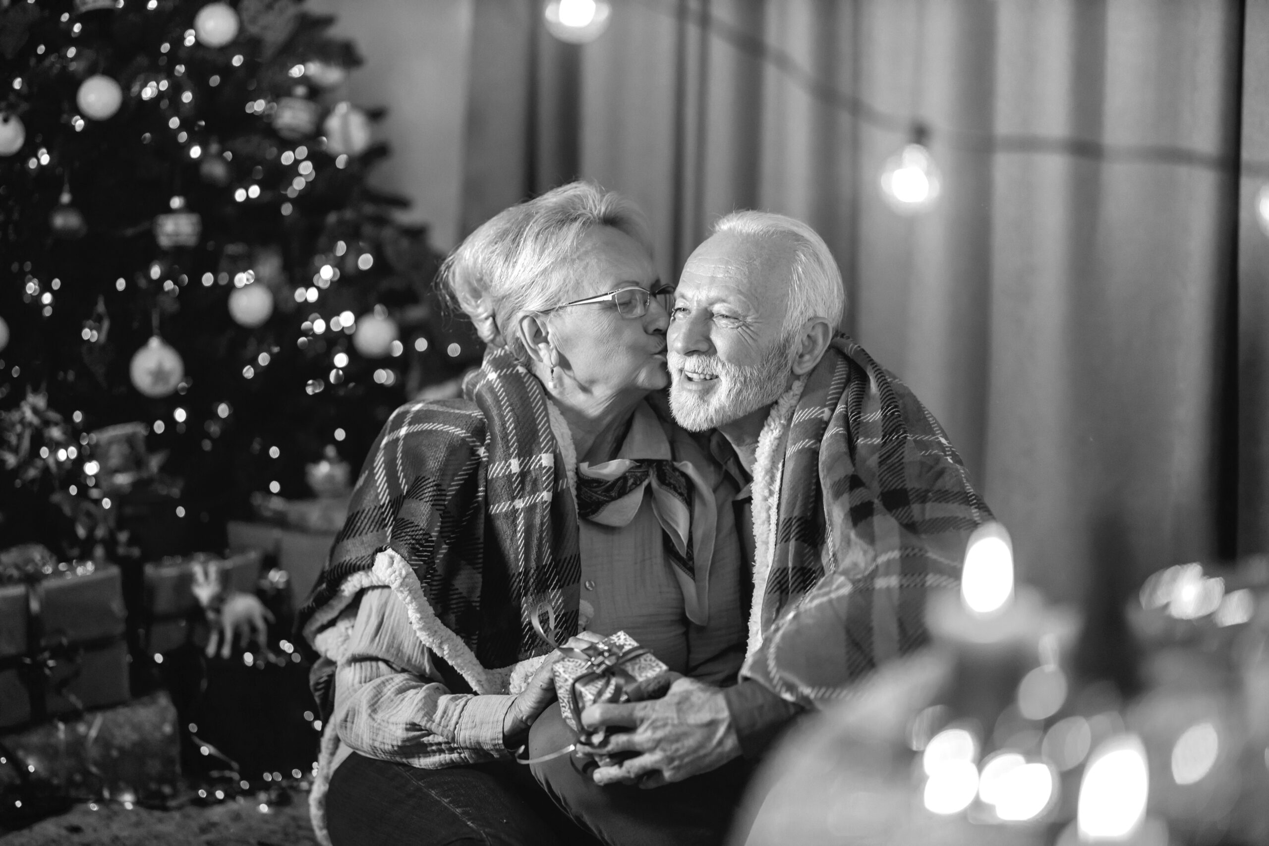 A senior couple celebrating New Year and christmas at home while